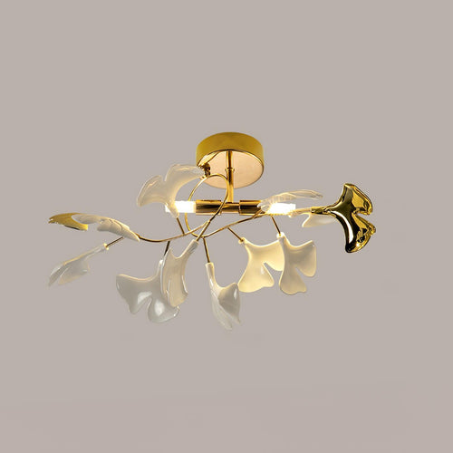 Ceramic ginkgo leaf ceiling light glowing warm against a pale wall