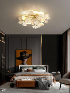 Warm-lit ceramic ginkgo leaf ceiling fixture from below