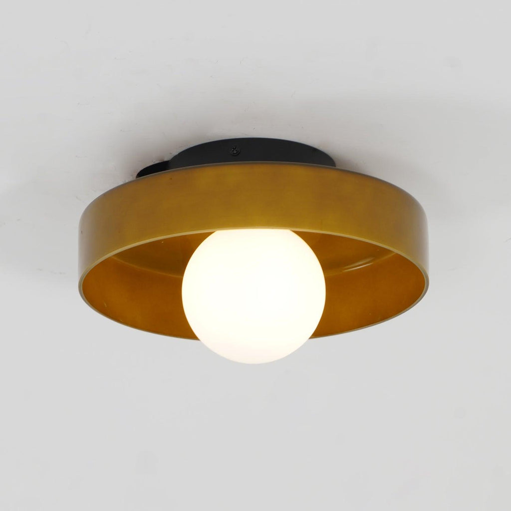 Lit against a plain grey backdrop, this Clérachic ceiling light in warm brown glass glows softly from within.