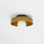 Photographed against a plain wall, this Clérachic ceiling light in warm brown glass sits unlit with its mounting plate visible.