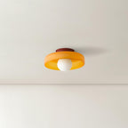 This Clérachic ceiling light in orange glass, seen from a distance in a room with a plastered archway.