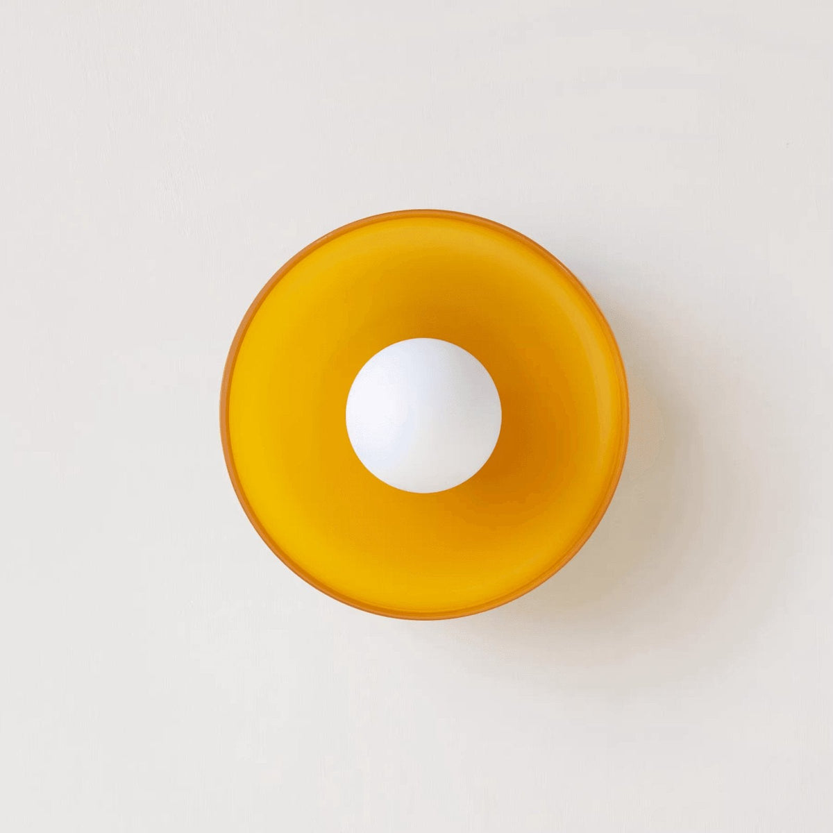 A white disc-shaped wall light, a different mount from this Clérachic ceiling light.