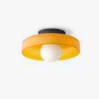 Front view of this Clérachic ceiling light in orange glass, the round shade centred above its white ball.