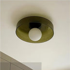 Mounted above a tiled wall, this Clérachic ceiling light in warm brown glass glows softly with its ball lit.