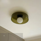 Above a run of pale cabinetry, this Clérachic ceiling light in warm brown glass sits unlit against the ceiling.