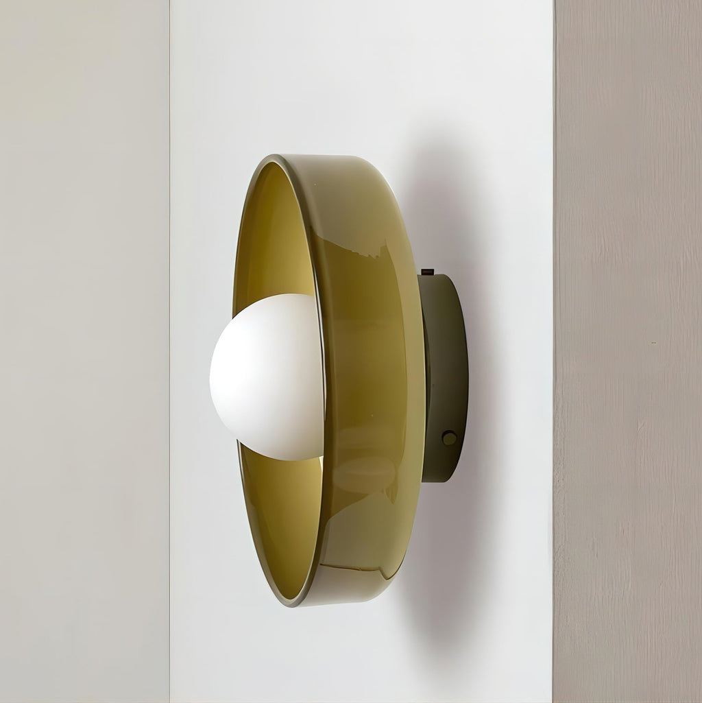 A brown-toned disc wall light mounted at a wall's edge, a different fixture from this Clérachic ceiling light.