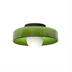 This Clérachic ceiling light in green glass, its dark mounting plate visible, ball unlit against a plain backdrop.
