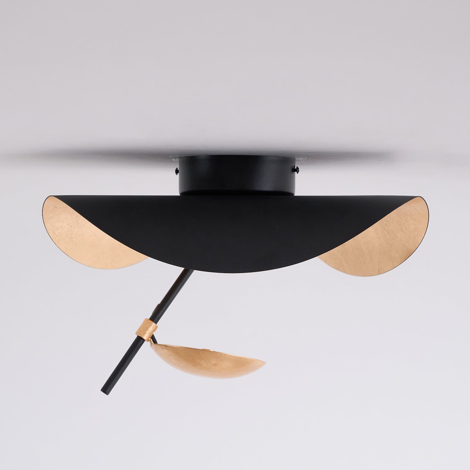 Curved disc ceiling light on a neutral background