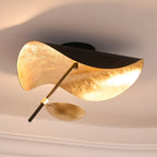 Curved disc ceiling light seen edge-on, lit warm