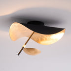 Curved steel disc ceiling light above a seating area
