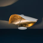 Curved steel disc light reaching out on its rod