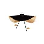 Curved steel disc ceiling light above a calm interior