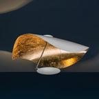 Curved disc ceiling light reaching from a slim rod