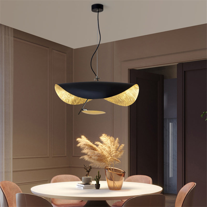 Disc pendant light with gold underside and soft downward glow