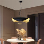 Disc pendant light with gold underside and soft downward glow
