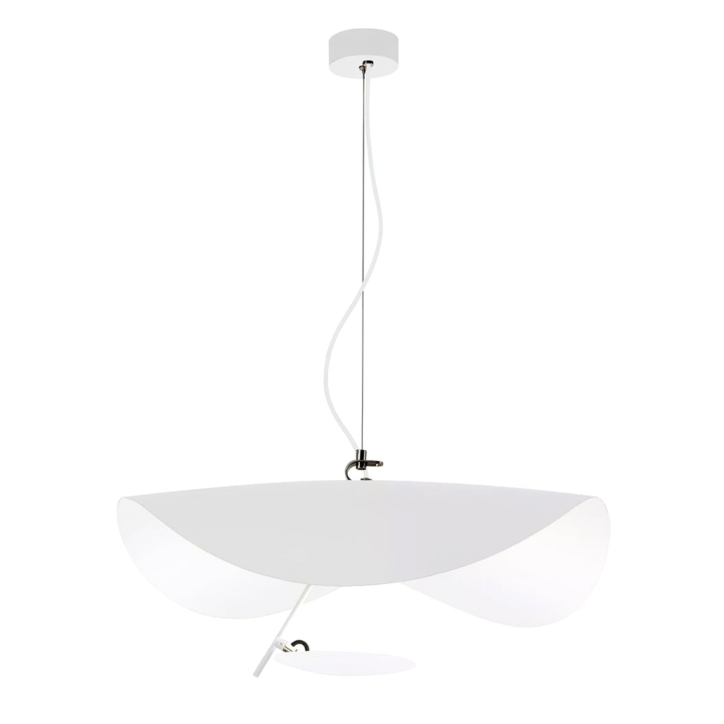 Curved disc pendant light glowing above a dining setting