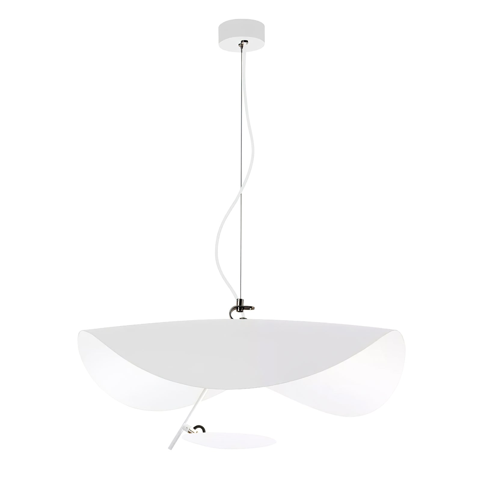 Curved disc pendant light glowing above a dining setting