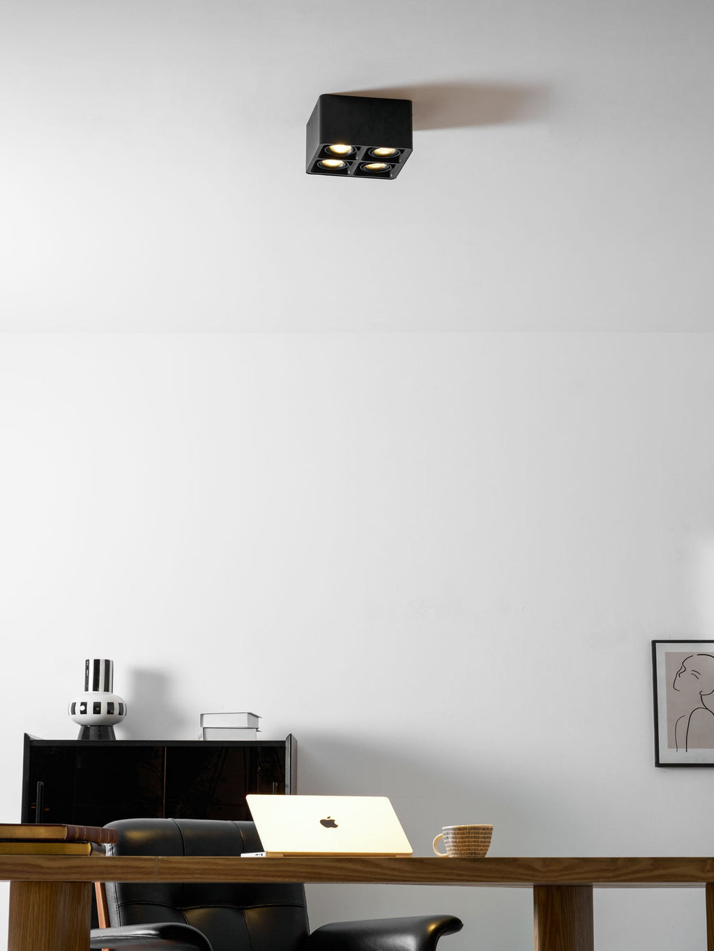 Back in the same home office, a single black Clérachic spotlight sits unlit on the ceiling above the desk.