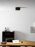 A closer view of the same office ceiling shows a single black Clérachic spotlight sitting unlit.