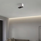 Above a bed beside an indirect light strip, a white two-light Clérachic spotlight sits unlit on the ceiling.