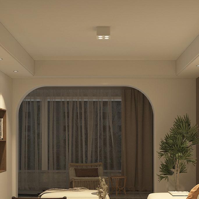 Beneath a decorative archway, a white two-light Clérachic spotlight glows warm above a dining table.