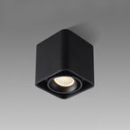 This black single-light Clérachic spotlight is shown unlit at an angle against a plain grey background.