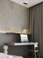 Above a desk with a monitor, a white single-light Clérachic spotlight sits unlit on the ceiling.
