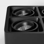 Close view of two lamp heads on this black Clérachic spotlight, unlit, showing the ribbed reflector cones.