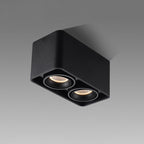 This black two-light Clérachic spotlight is shown unlit at an angle against a plain grey background.