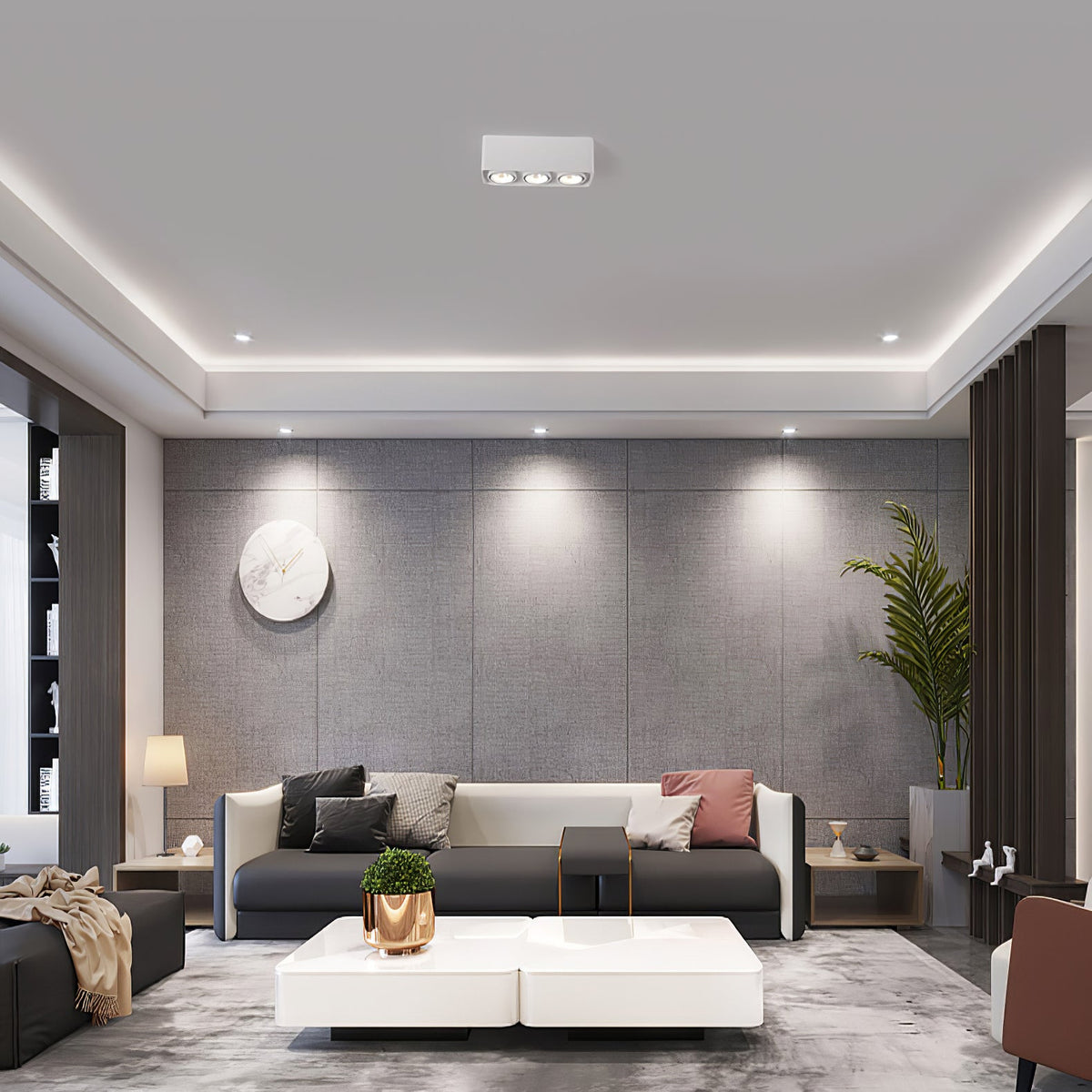 Alongside recessed downlights, a white three-light Clérachic spotlight glows warm above a grey sofa.