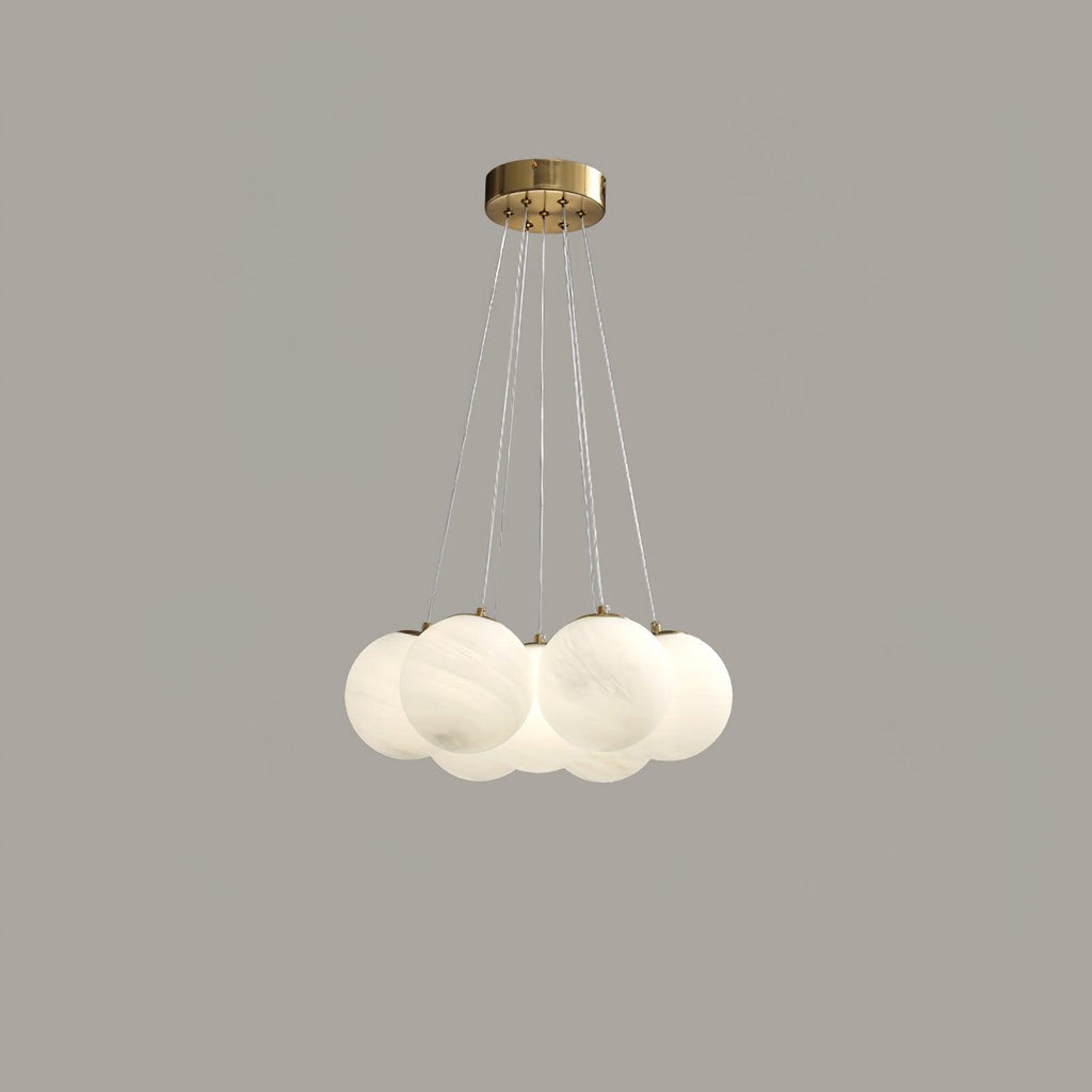 Suspended on fine cords against a plain grey backdrop, this Clérachic cluster chandelier's frosted globes cluster closely together.