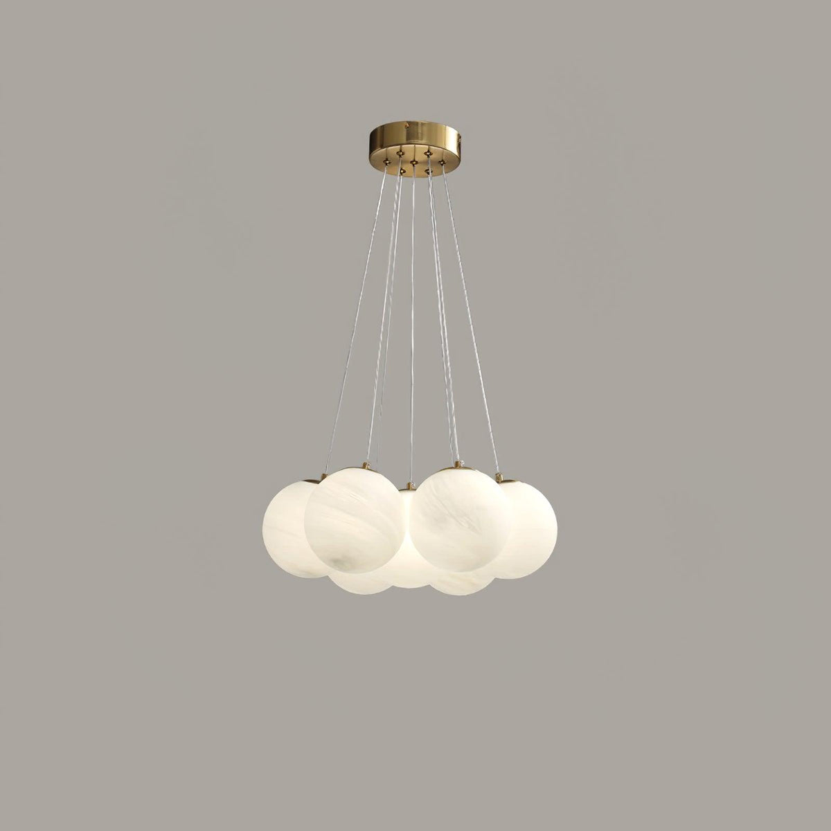 Suspended on fine cords against a plain grey backdrop, this Clérachic cluster chandelier's frosted globes cluster closely together.