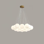 On a grey backdrop, this unlit Clérachic cluster chandelier's frosted globes hang from widely fanned cords.