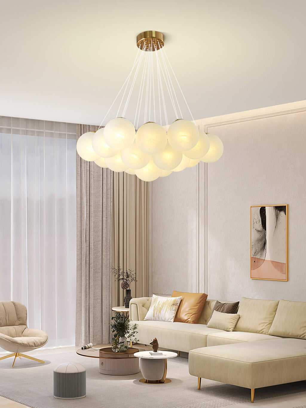 A sectional sofa and framed art sit beneath this lit Clérachic cluster chandelier in a light living room.