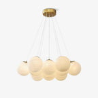 Another studio view of this lit Clérachic cluster chandelier, its frosted globes glowing warmly beneath fine cords.