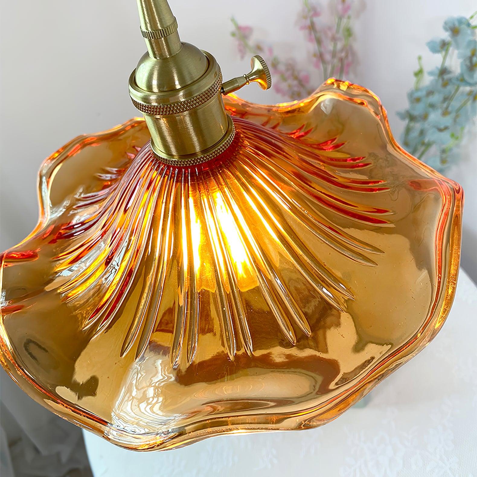Fluted hibiscus glass pendant light against a soft grey wall