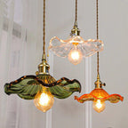 Hibiscus glass pendant light glowing softly in a warm interior