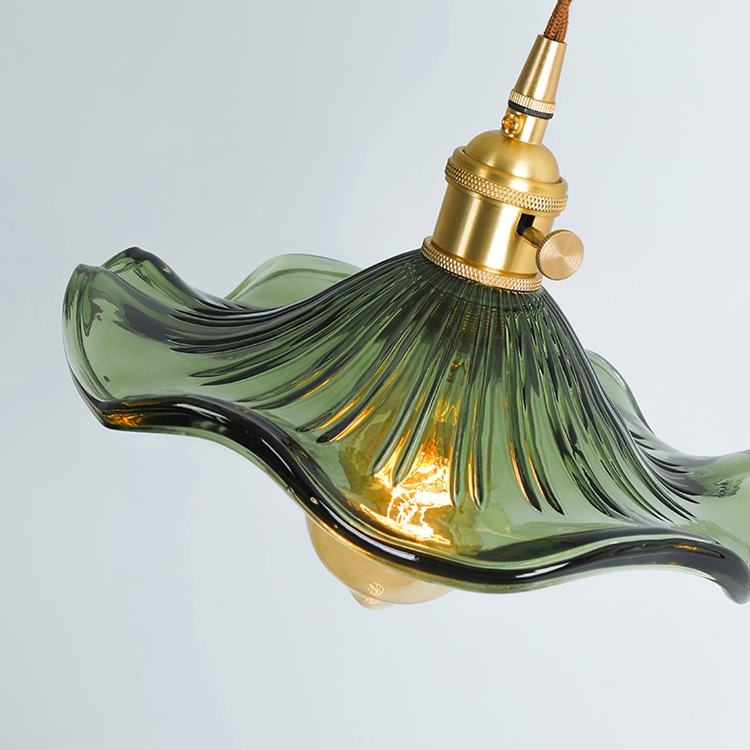 Glass hibiscus pendant light shown lit in a cosy hallway