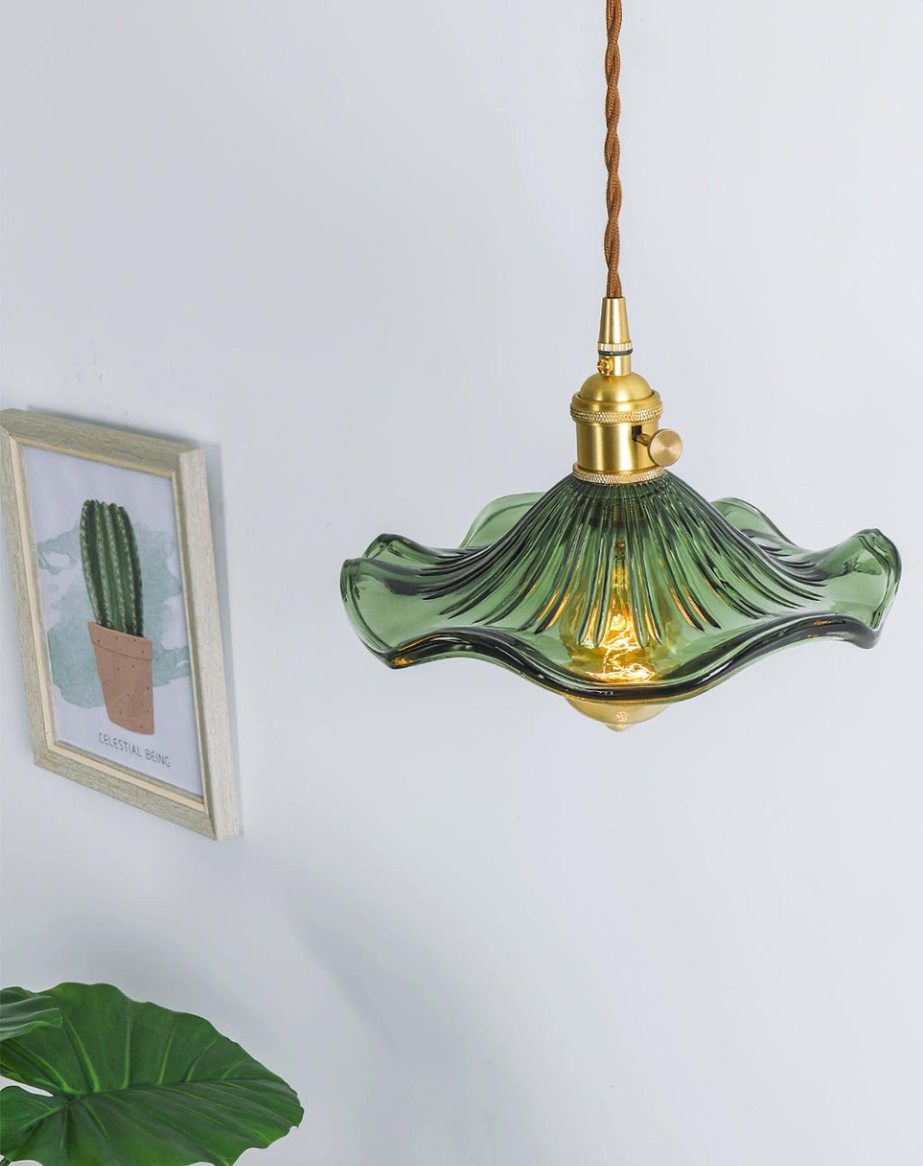 Hibiscus glass pendant light with warm filament glow detail