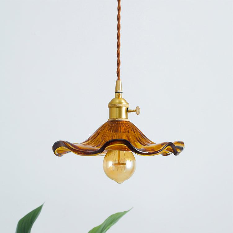 Brass hibiscus swag light with warm filament bulb glow