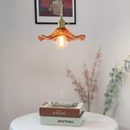 Brass hibiscus pendant light with warm Edison bulb glow