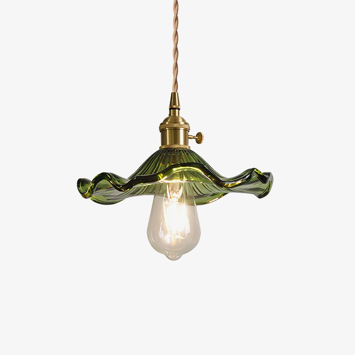 Hibiscus glass pendant light shown lit against a dark wall