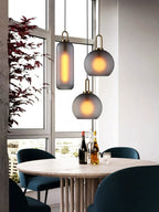 Glass pendant light styled above a dining setting with soft glow