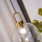 Glass pendant light cluster casting warm light over a room