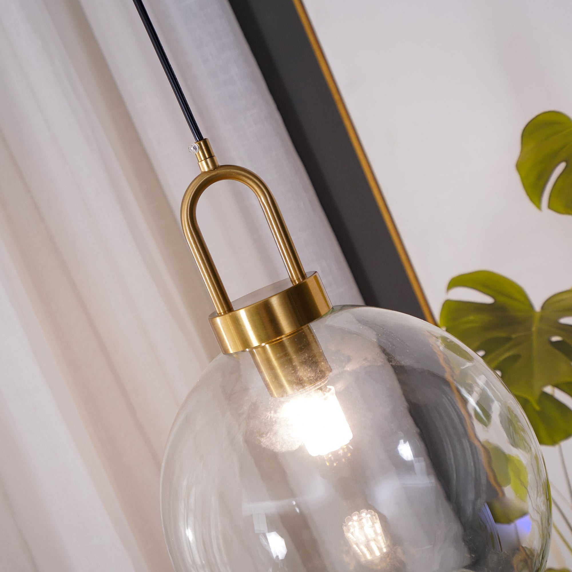 Glass pendant light cluster casting warm light over a room