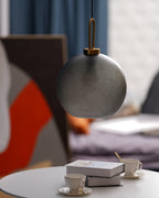 Glass pendant light glowing warmly in a styled living space