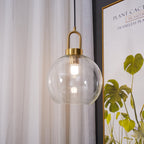 Glass pendant light close-up with warm Edison filament glow