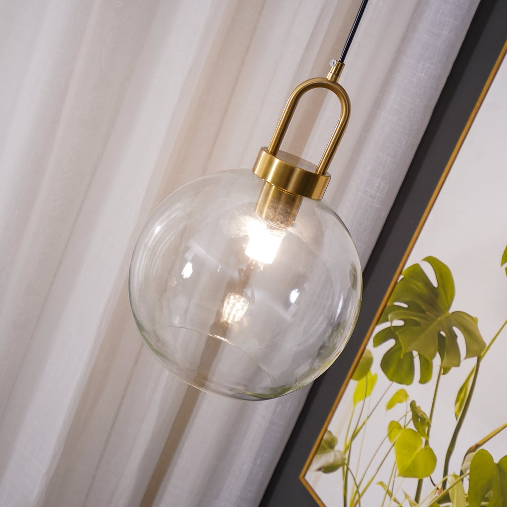 Glass pendant light detail with copper-plated body and cable