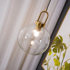 Glass pendant light detail with copper-plated body and cable