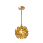 Handblown glass petal pendant light shown lit in a hallway